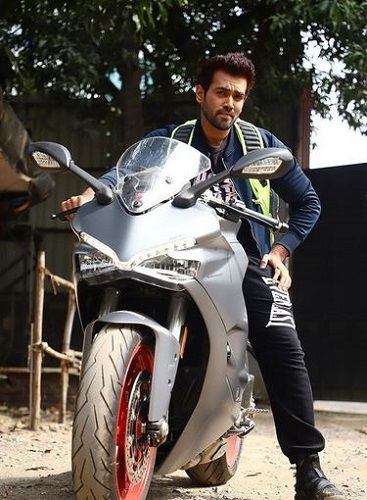 Karan Khanna posing with his Ducati motorcycle