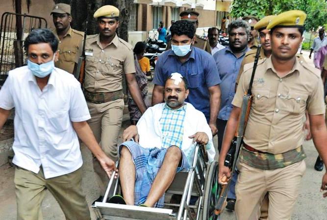 Police officials taking Perarivalan to a hospital after an inmate in the jail attacked him