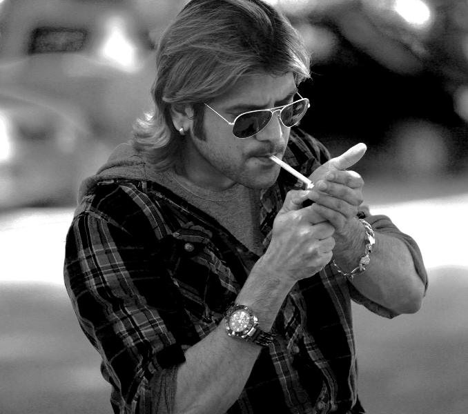 Firoz Khan smoking a cigarette