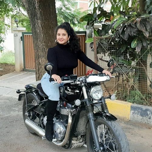 Shubha Poonja posing on her motorcycle