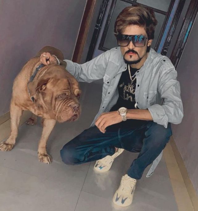 Haji Ali Agariya posing with his pet dog