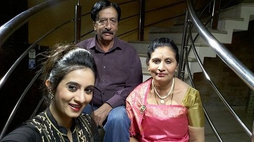 Harshika Poonacha with her parents
