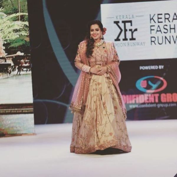 Remya Panicker walking down the runway for a fashion show