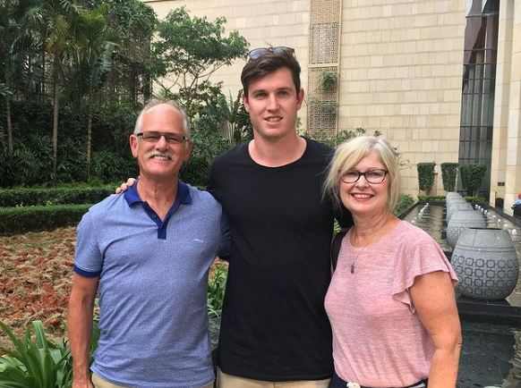 Adam Milne with his parents