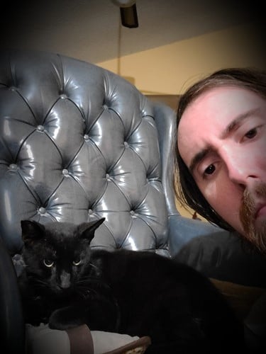 Asmongold with his pet cat, Brother
