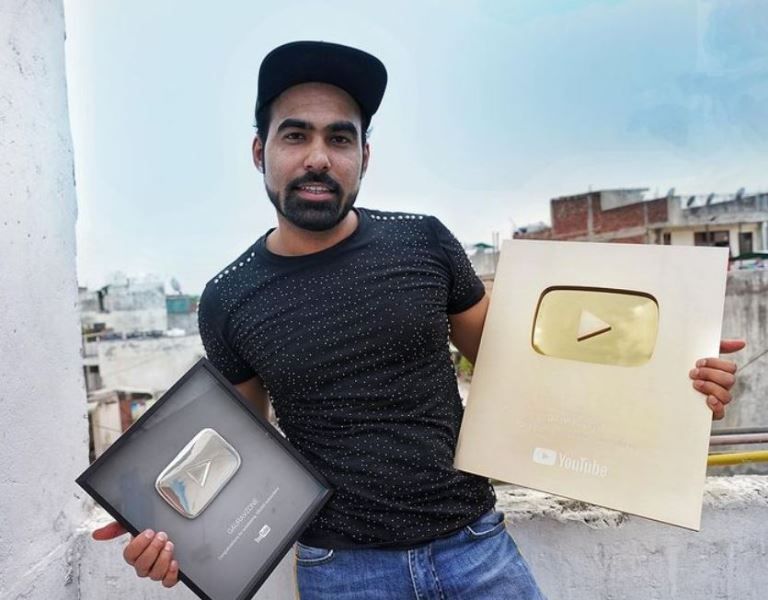 Gaurav Sharma holding his YouTube play buttons