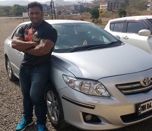 Jagdish Lad posing with his car