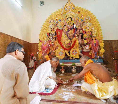 Abhijit Mukherjee (left) with Pranab Mukherjee (in white) performing Durga Puja