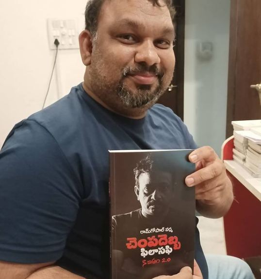 Mahesh Kathi holding the book Slap Philosophy