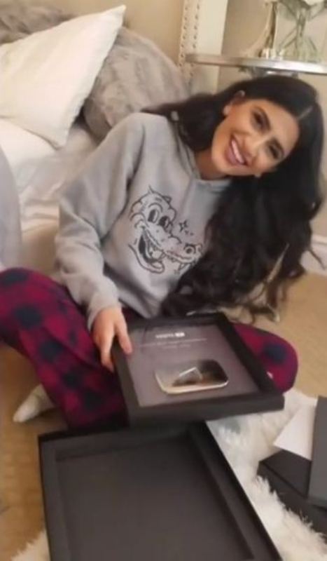 Puneet Kaur holding her YouTube silver play button