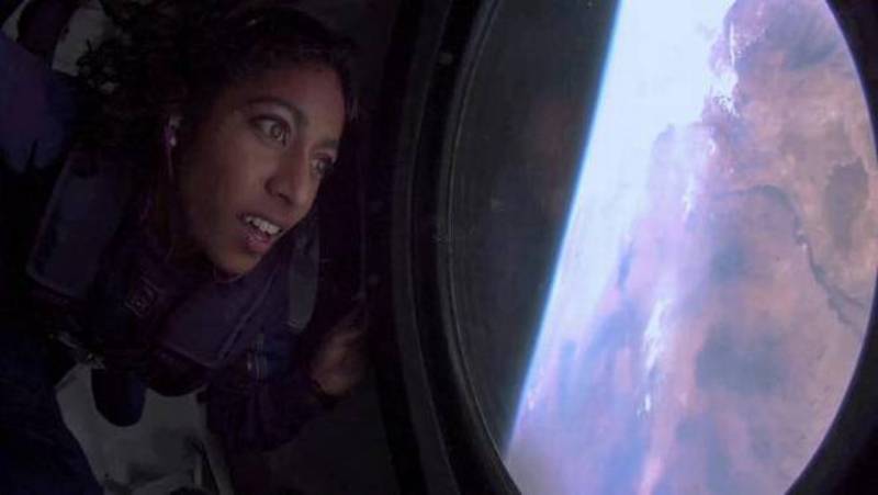 Sirisha Bandla looks out the window at Earth in zero gravity on board Virgin Galactic's passenger rocket plane VSS Unity after reaching the edge of space on July 11, 2021