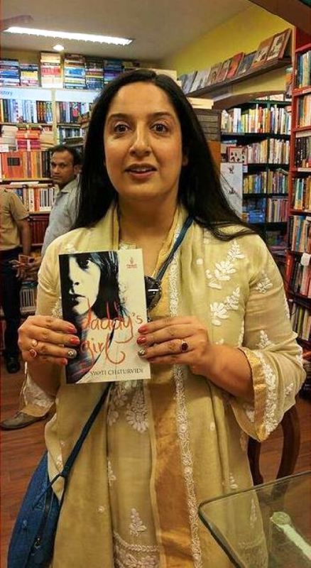 Swati Chaturvedi holding her debut book Daddy's Girl