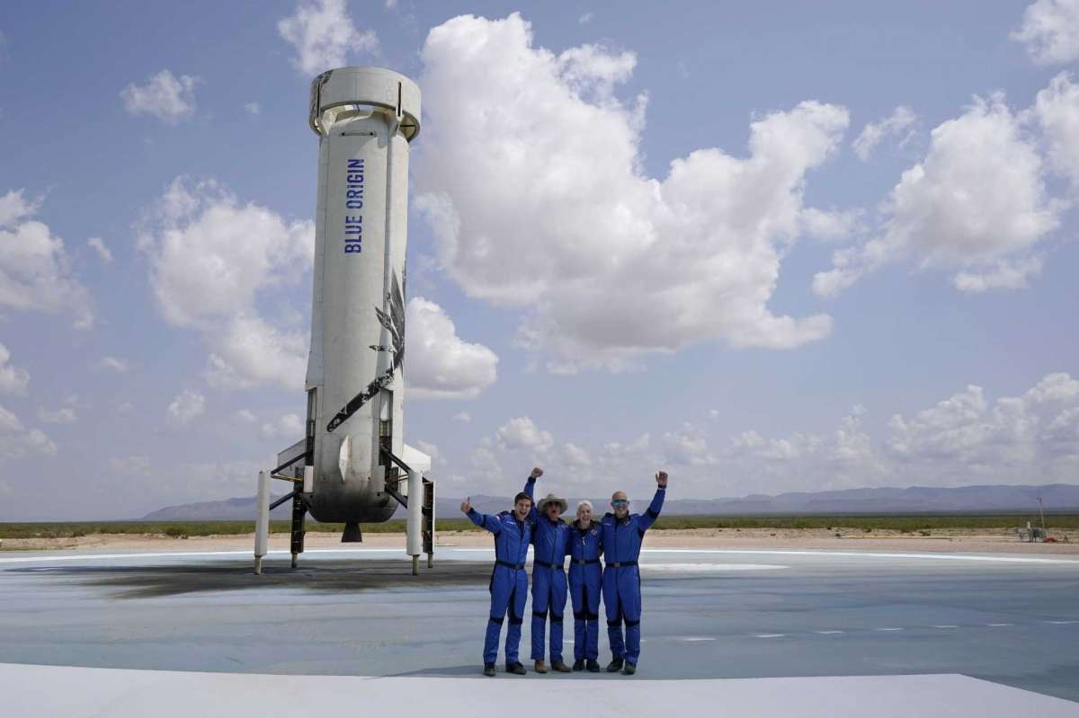Wally Funk (2nd from right) posing in front of Blue Origin shuttle