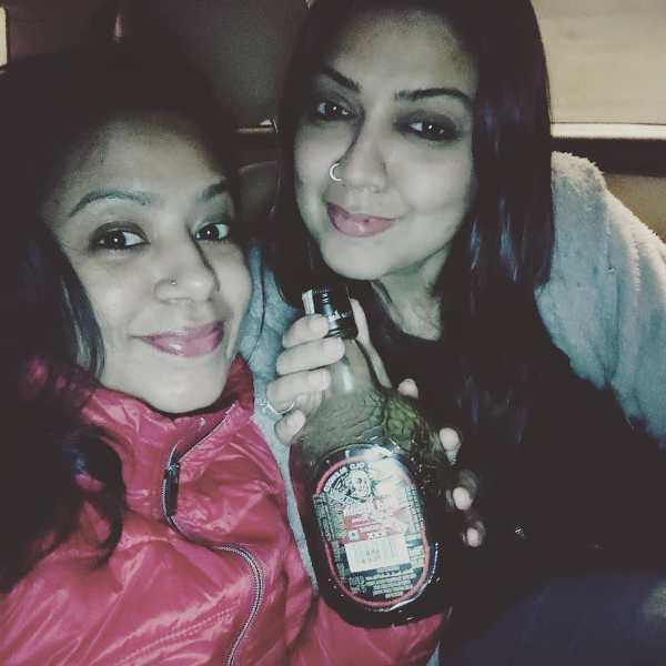 Deepika Bhardwaj while showing a bottle of alcohol amid a celebration party