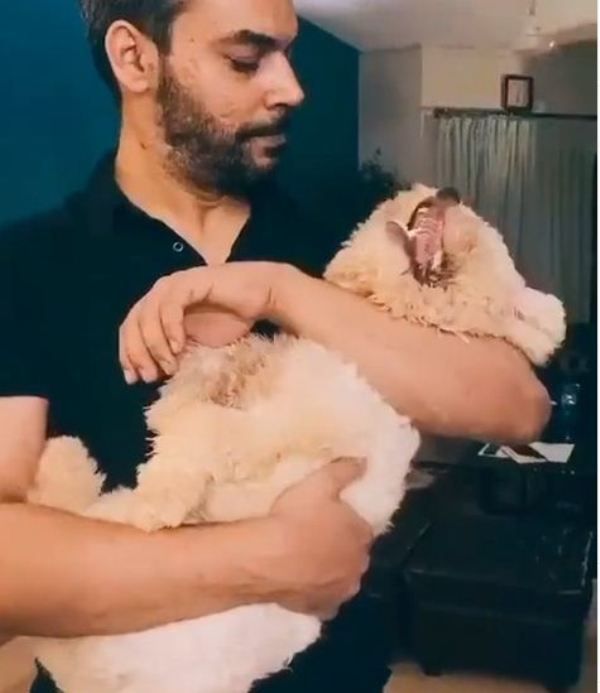 Gohar Rasheed holding his pet Barfi