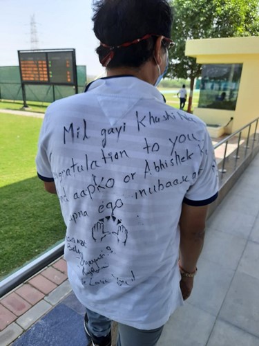Jaspal Rana wearing a white t-shirt with a message