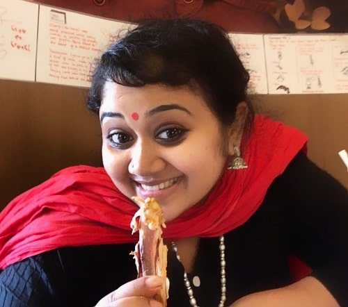 Saranya Sasi eating in a restaurant