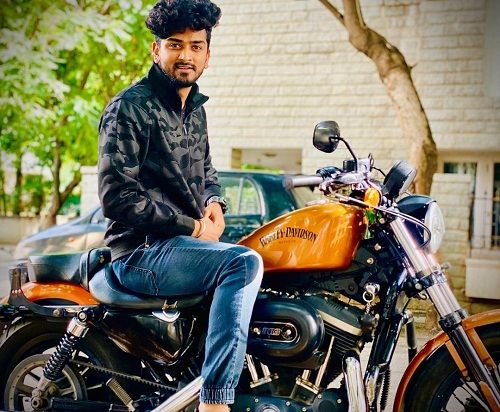 Shamanth Gowda posing on his Harley Davidson motorcycle