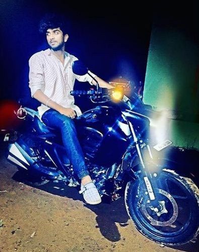 Shamanth Gowda posing on his motorcycle