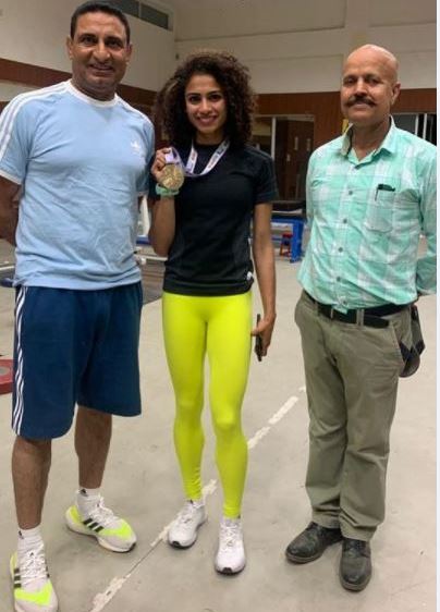 Harmilan Kaur with her medal won at the National Federation Cup 2021 alongwith her father (L) and coach