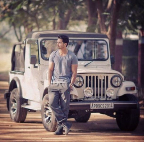 Harshvardhan posing with his jeep