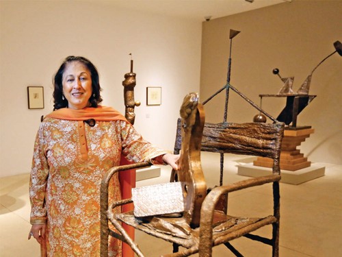 Kiran Nadar at her art gallery with an art sculpture