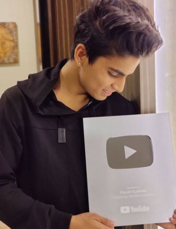 Piyush Gurbhele holding his silver YouTube play button
