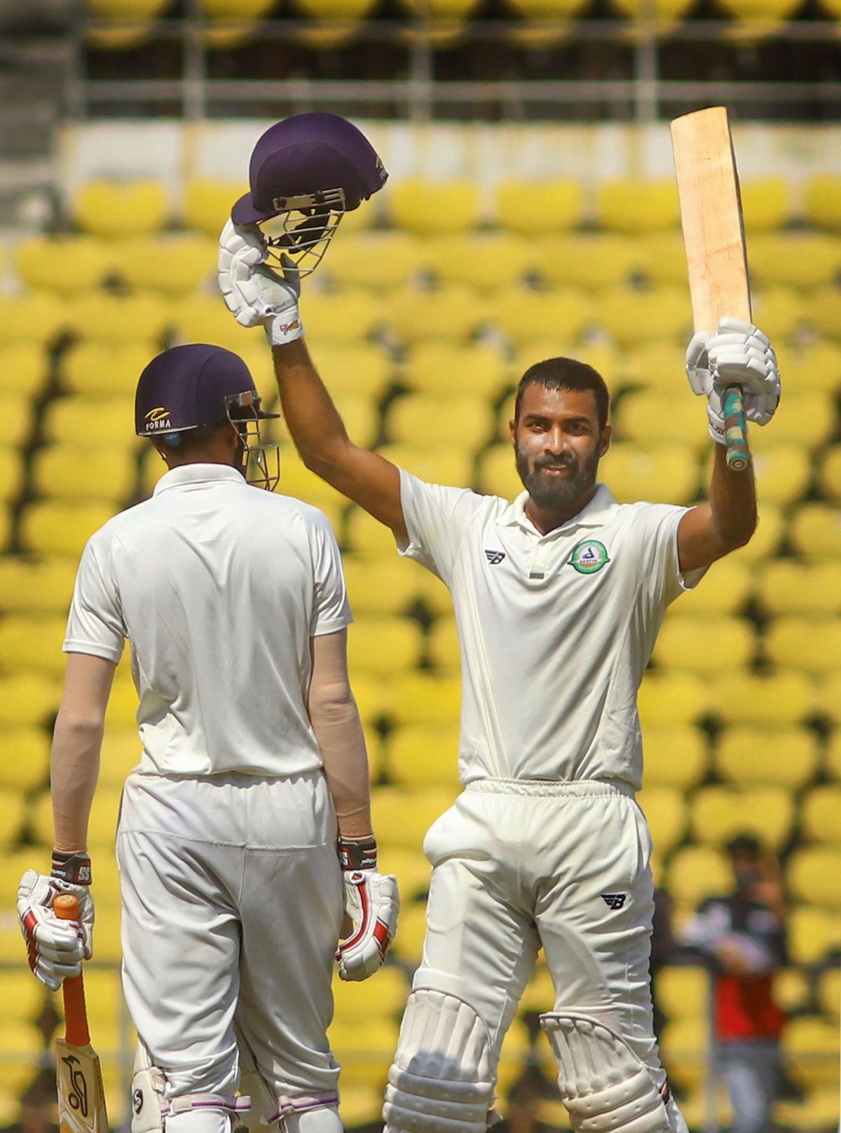 Akshay Karnewar raising his bat after scoring a century against Rest of India during a Irani Trophy match in 2018-19
