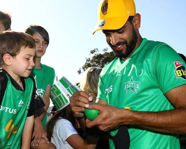 Harris Rauf giving autograph to his fans during BBL in Australia