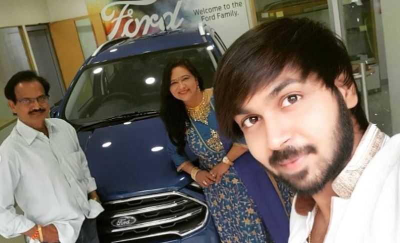 Maanas and his parents posing with Ecosport Ford car