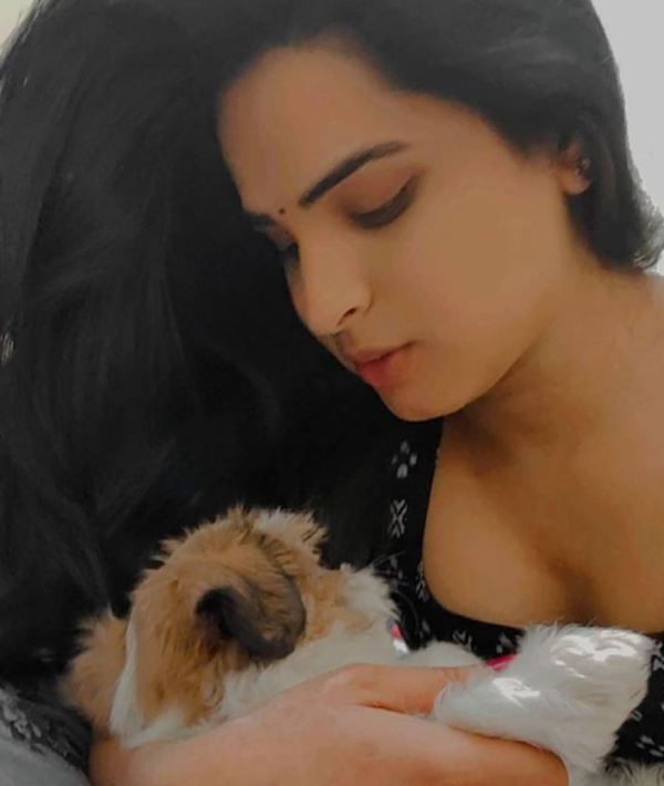 Priyanka Singh while posing with her pet dog