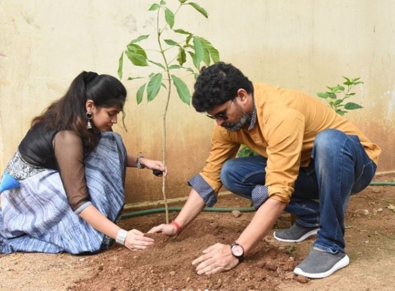Ravi Kiran while planting a tree with his wife