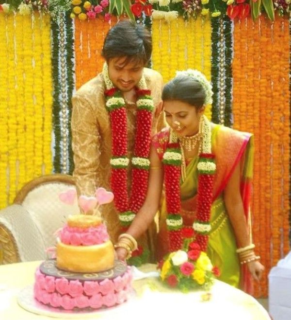 Chirag cutting cake with his wife on their wedding day