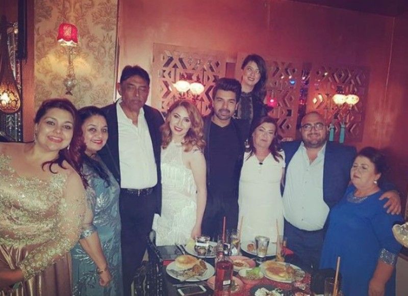 Melis and Vipul with their family during engagement party