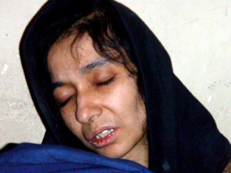 In this 17 July 2008, file photo, Aafia Siddiqui is seen in the custody of Counter Terrorism Department of Ghazni province in Ghazni City, Afghanistan