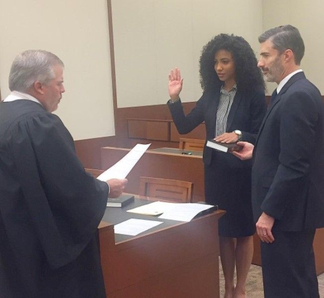 Kryst, along with her stepfather David (right), taking oath as the attorney