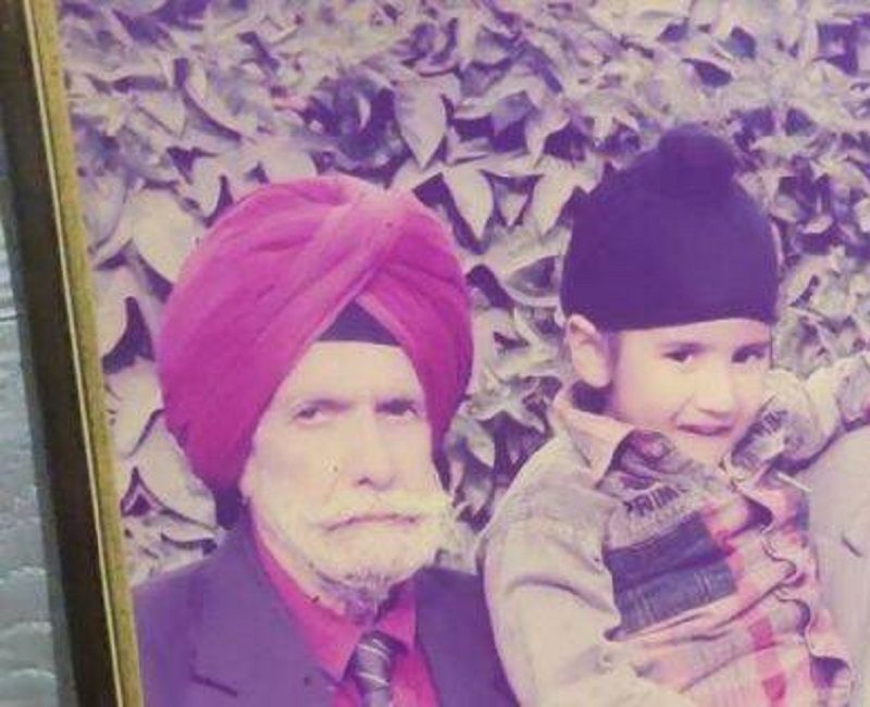 A photo frame of Raj (as a kid) with his grandfather