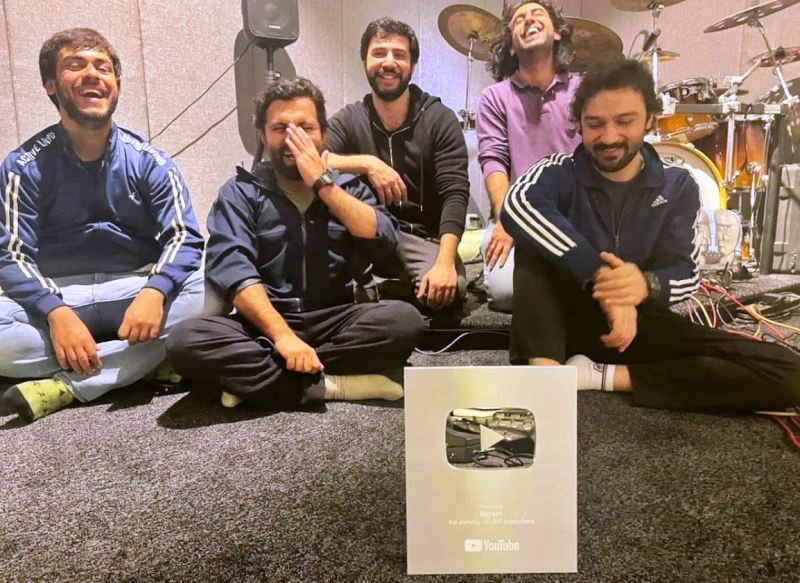 A picture of members of the band Bayaan posing with its Silver Creator Award in 2022