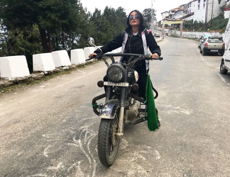 Chum Darang posing with her motor bike
