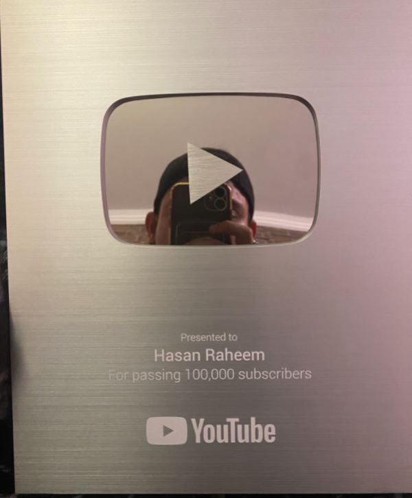 Hasan Raheem while showing his Silver YouTube button after passing one lakh subscribers on his YouTube channel