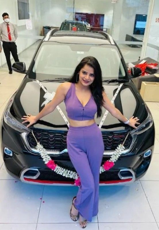 Archana Gautam posing with her car