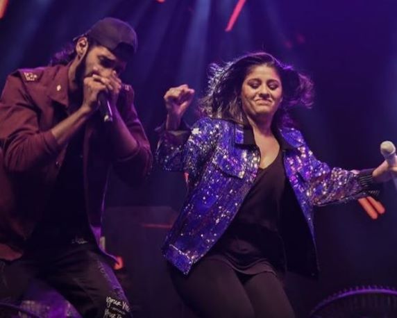 Divyansh while performing a music concert with Sunidhi Chauhan