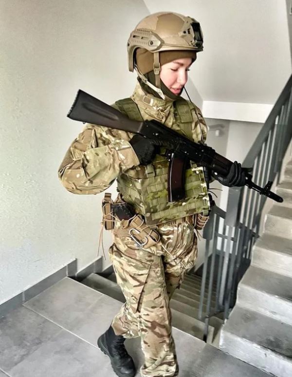 Anastasiia Lenna in combat uniform with a gun