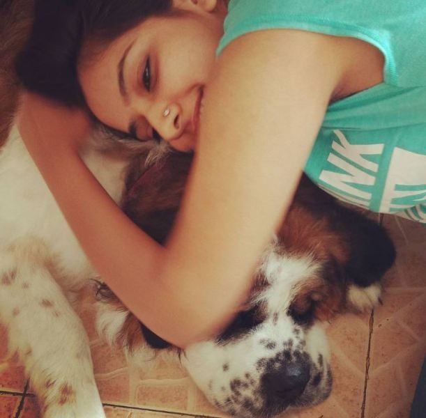 Chakori Dwivedi cuddling with her pet dog