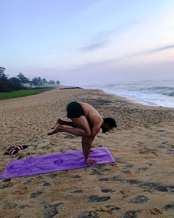 John Kokken doing Yoga at a beach