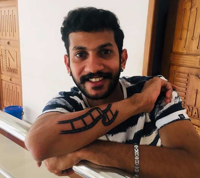 Akhil Kutty showing his tattoo