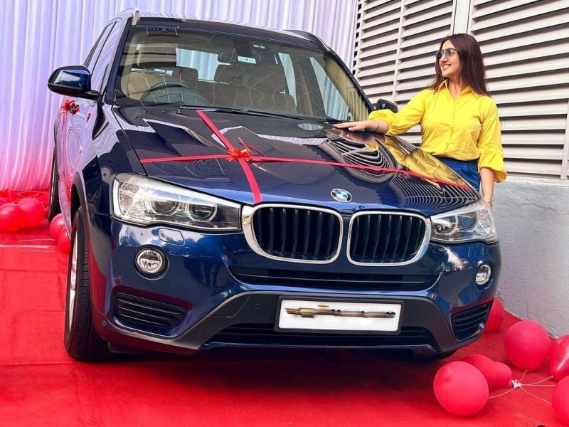 Ashnoor Kaur with her BMW car