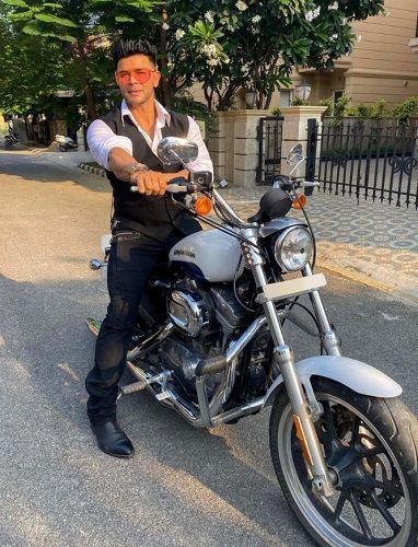 Sahil Khan sitting on his Harley-Davidson motorcycle