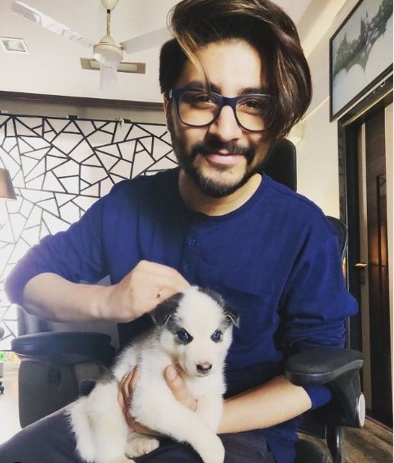 Arjuna Harjai posing with a dog