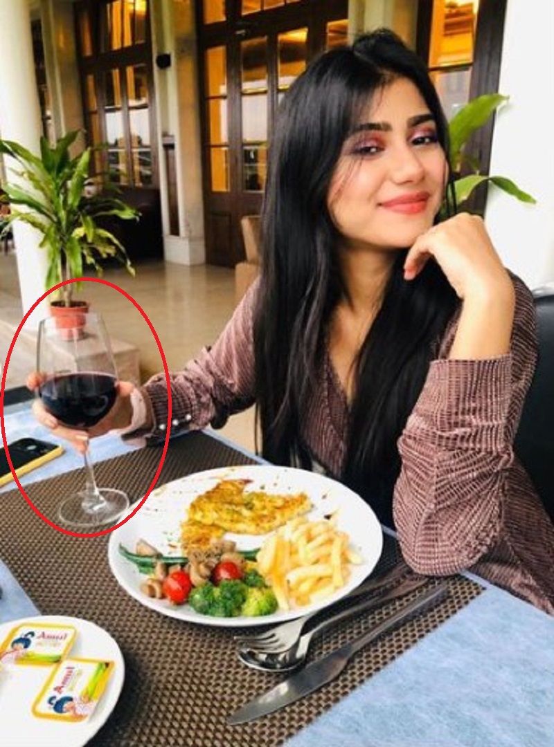 Prantika Das holding a glass of wine